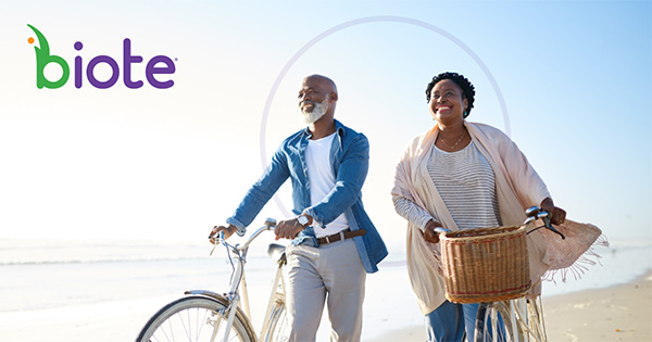 Biote - elderly couple riding bikes on the beach